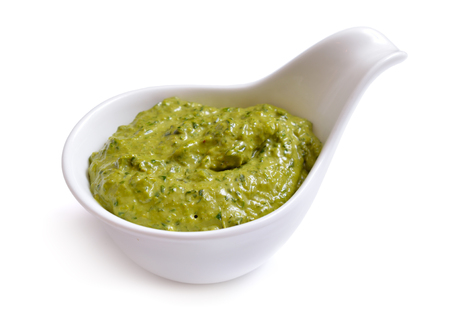 Pesto sauce in a bowl. Isolated On white.の写真素材