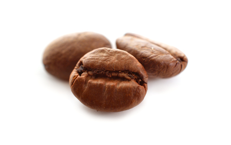 Roasted coffee beans isolated in white backgroundの写真素材