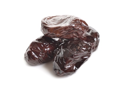 Three Sun-dried olives isolated on white background.の写真素材