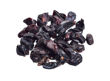 Dried black Berberis. Isolated on white background.の写真素材
