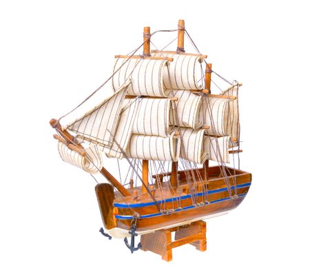 Small wooden souvenir boat isolated on white background.の写真素材