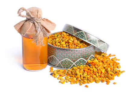 Bee pollen baskets with pharmaceutical bottle. Isolated on white background,の写真素材