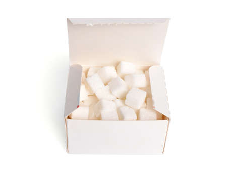 Heap of Sugar cubes on the box isolated on white backgroundの写真素材