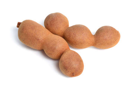 Ripe tamarind fruit isolated on white backgroundの写真素材