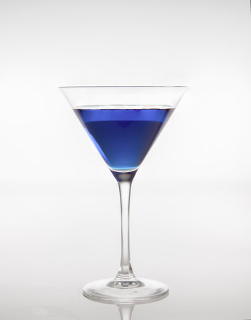 Blue cocktail in a glass isolated on a white background.の写真素材