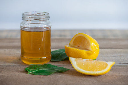 Honey and lemon ready to be made into a soothing drink.の写真素材