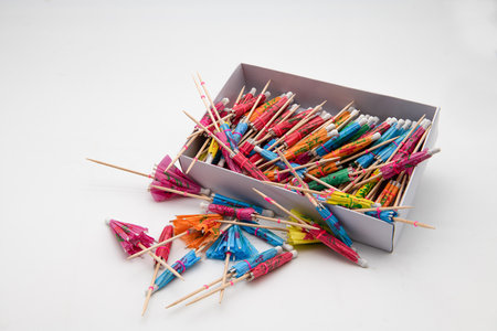 Open box of oriental style parasol cocktail sticks ioslated on a white background.の写真素材