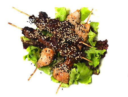 Yakitori with sesame seeds. Fried chicken meat and chicken liver on sticks close-up isolated on white background. Top viewの写真素材