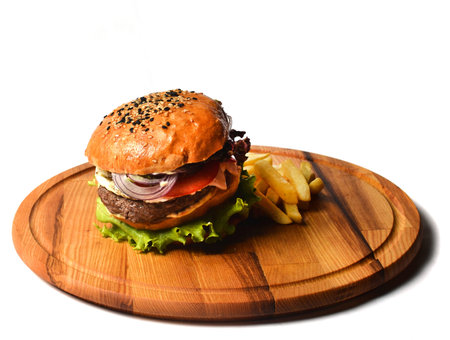 Burger with french fries on a wooden board. Fast food isolated on white background.の写真素材