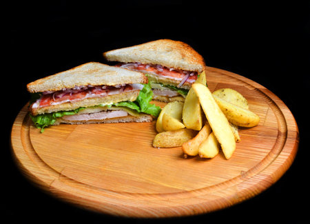 Sandwich with baked potatoes on a wooden board isolated on white background. Restaurated food. Fast food.の写真素材