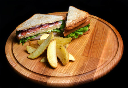 Sandwich with baked potatoes on a wooden board isolated on white background. Restaurated food. Fast food.の写真素材