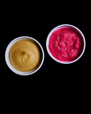 Horseradish and mustard on a black background.Sauces for food. Top view.の写真素材