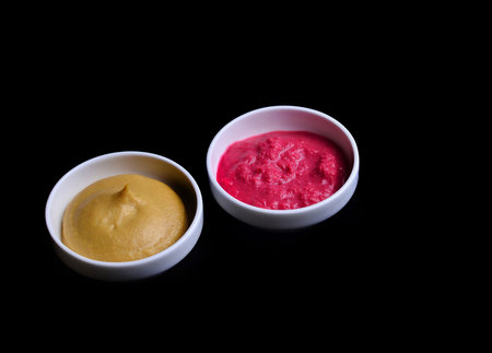 Horseradish and mustard on a black background.の写真素材