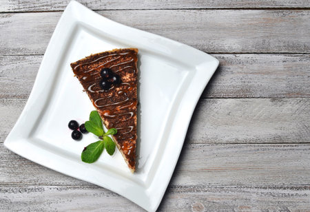 Cheesecake with chocolate on a wooden table. Top view.の写真素材