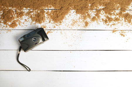 Vintage camera on a white wooden surface. The concept of relaxing at sea. Summer beach season is open! Top view.の写真素材