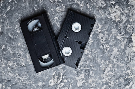 Vhs video cassettes on a concrete table. Retro technology from the 80s. Top view.