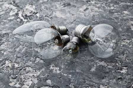 Many different types of incandescent bulbs on a gray concrete background. The interior is loft style.の写真素材