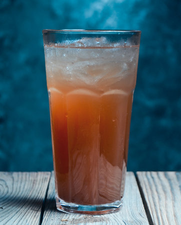 Carrot cocktail on the table on the wall background. Mystical light.の写真素材