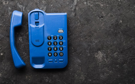 Office keyphone on a black concrete table. Top view.の写真素材