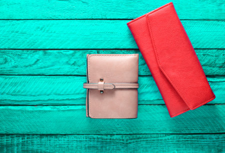 Female purse on a turquoise wood background. Fashionable women's accessories. Top view.