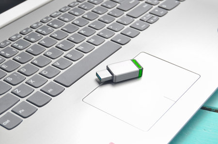 USB flash drive on the laptop keyboard. Modern media technologies.の写真素材