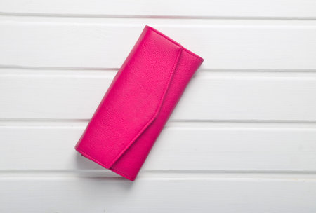 Red woman's purse on white wooden table. Top view.の写真素材