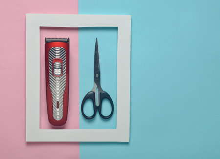 A clipper and scissors in a white frame on a colored pastel background. Minimalist trend. Copy...