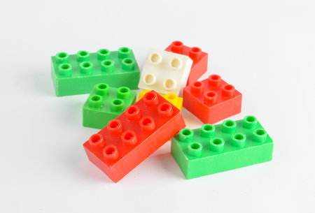 Colorful toy bricks of a children's designer on a white background.