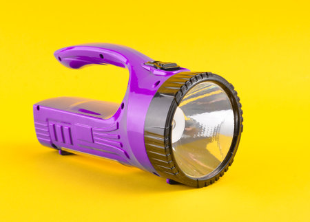 Purple flashlight isolated on a yellow backgroundの写真素材