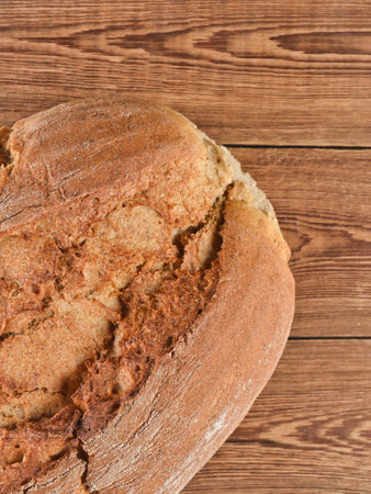 A loaf of rye bread on a wooden table