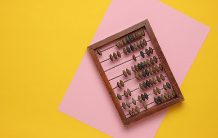Old retro wooden abacus on a colored pastel background. Top Viewの写真素材