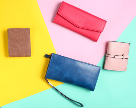 Many leather purses on a colored pastel background. Top View