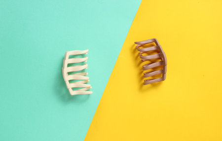 Hair clips on blue yellow pastel background. Top view, minimalismの写真素材