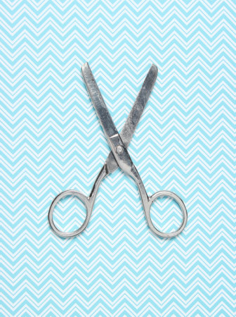 Old metal scissors on tablecloth. Top viewの写真素材