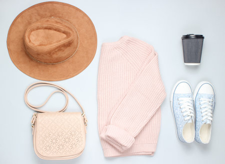 Fashionable knitted sweater, felt hat, leather bag, sneakers, leather bag on a gray background.Women's clothing and accessories. Top view.の写真素材