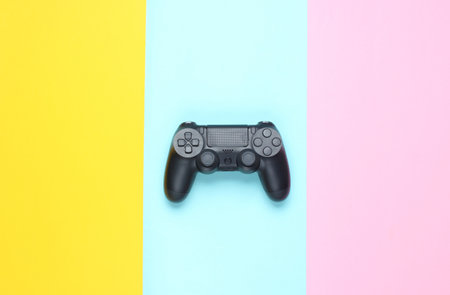 Gamepads on a colored paper background. Top view. Minimalismの写真素材