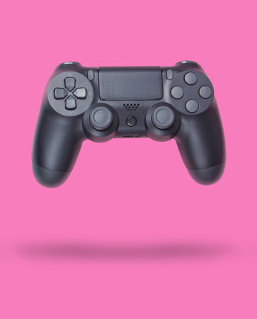Gamepads on pink pastel paper background. Top view. Minimalism