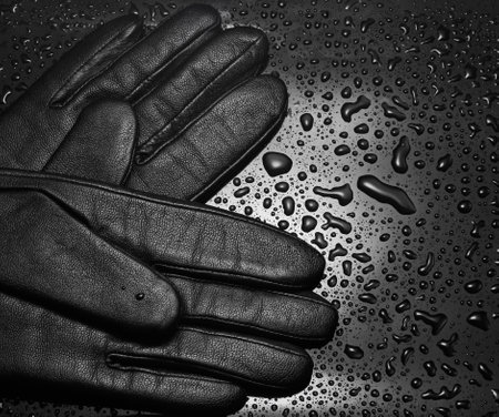 Leather gloves close-up on a black background with water drops. fashion conceptの写真素材
