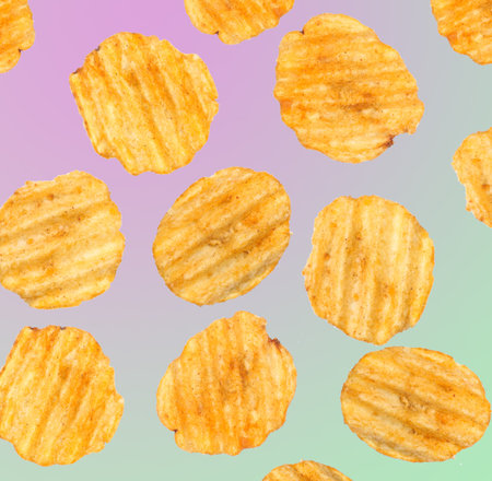 Many ribbed chips isolated on colored neon background.の写真素材