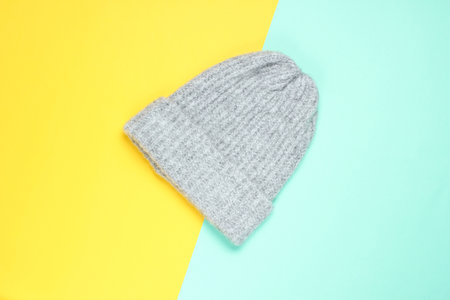 Winter woolen hat on a colored paper background, minimalism, top viewの写真素材