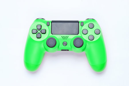 Modern green plastic gamepad (joystick) on gray background. Top view