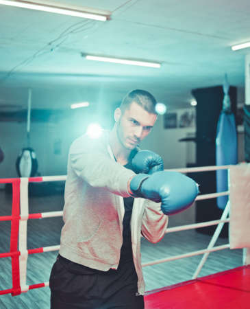 Men boxer doing shadow boxing inside boxing ring at gym. Boxer practicing his punches at a boxing studioの写真素材