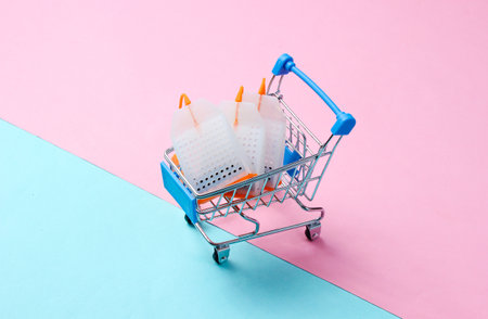 Tea bags in a toy shopping trolley on a pastel background. Conceptual photo.の写真素材