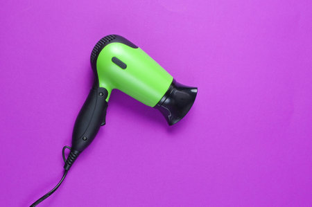 Hair dryer on a purple background. Top viewの写真素材