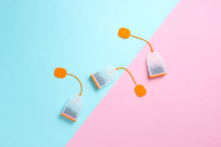 Three silicone tea bags on pink blue pastel background. Top view, minimalismの写真素材