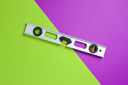 Construction level on green purple background. Minimalismの写真素材