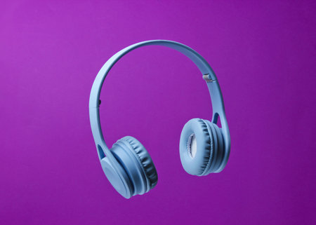 3D surround photo blue wireless headphones on a purple background.の写真素材