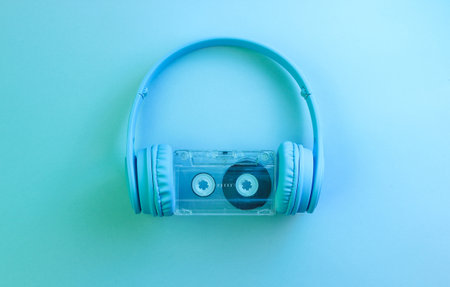 GÐ°mer concept. Gamepad with headphones. 80s. Retro wave, blue neon light, ultraviolet. Top view, minimalismの写真素材