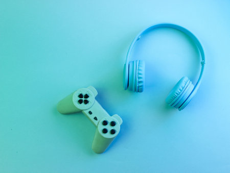 Gamer concept. Headphones and gamepad. Retro wave, neon light, ultraviolet. Top view, minimalismの写真素材