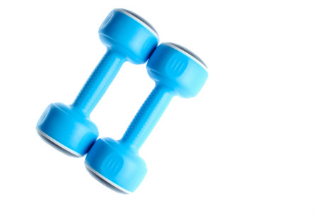 Two plastic blue dumbbells isolated on a white background. Sports concept.の写真素材